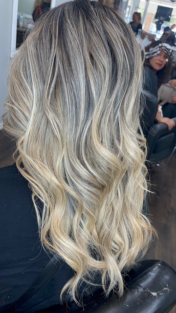 Dimensional blonde balayage with soft waves by Janeth