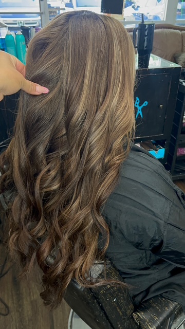 Brunette hair with caramel highlights and curls in Spring, TX